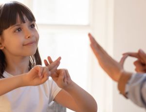 People communicating with British sign language
