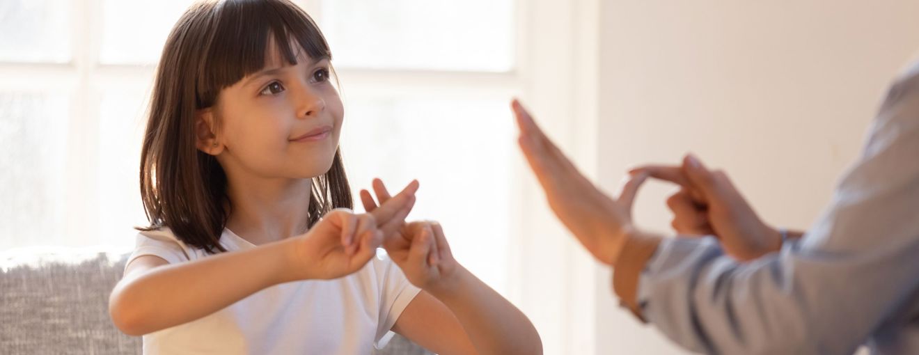 People communicating with British sign language