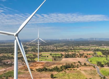 Wind turbines across a wide rural landscape on a clear, sunny day
