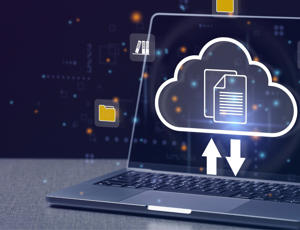 Laptop displaying a glowing cloud icon with upload and download arrows