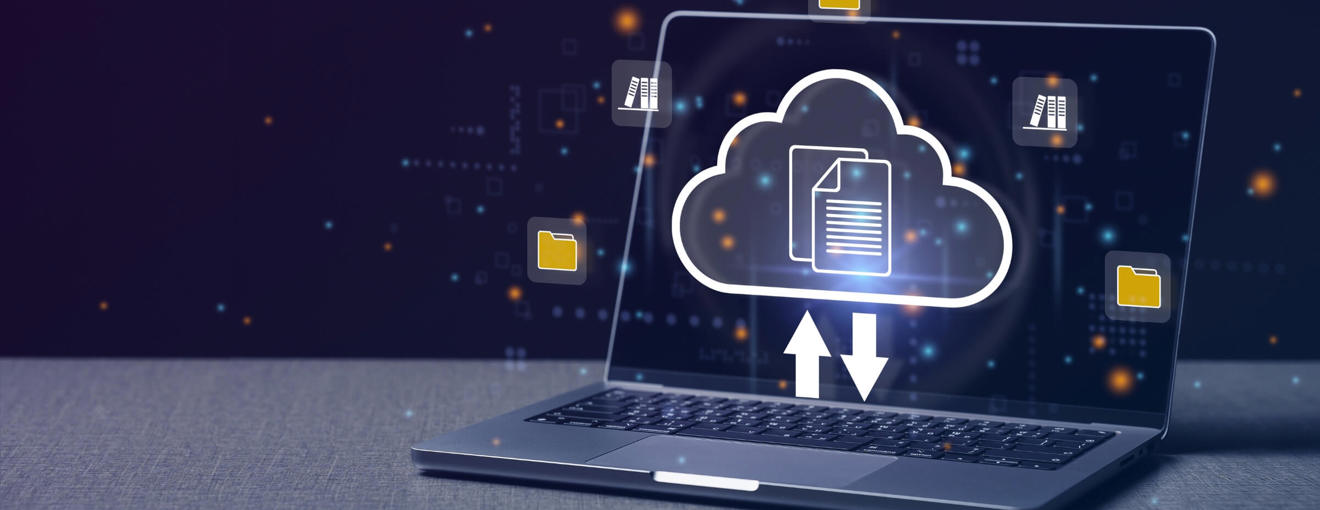 Laptop displaying a glowing cloud icon with upload and download arrows