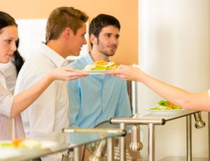People getting served food in a canteen