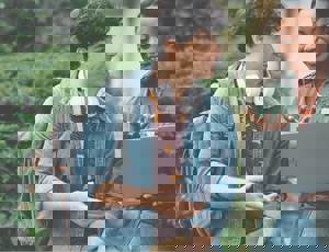 Two people smiling at a laptop