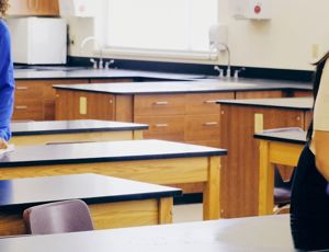 cleaners cleaning desks in a school