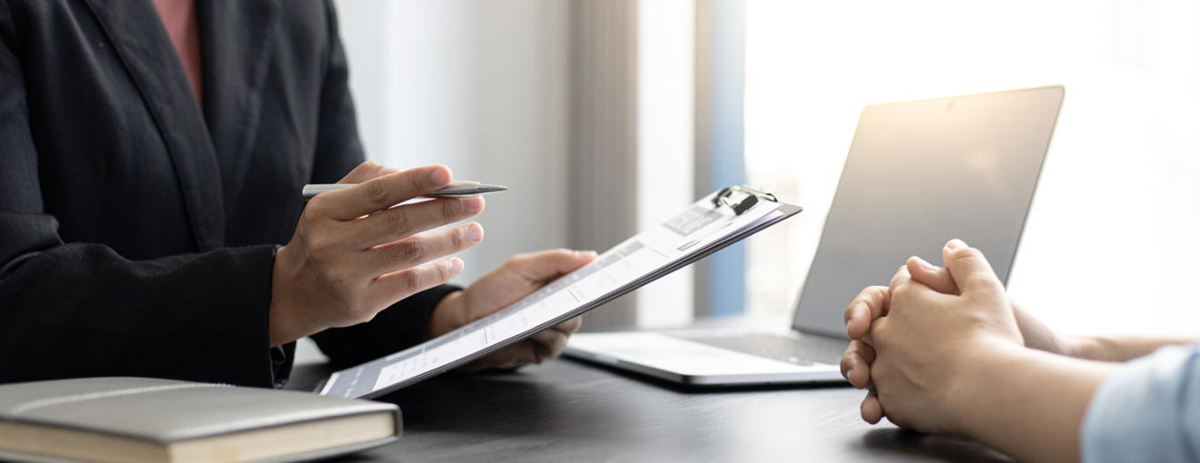 Two individuals seated at a desk