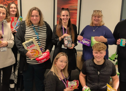 procurement services team holding food donations
