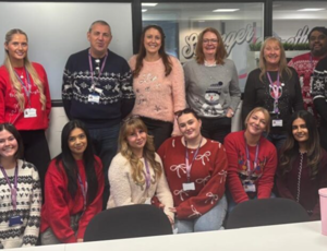 procurement services team wearing festive jumpers
