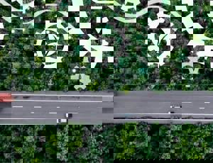 Road through a remote landscape with a technology graphic overlay