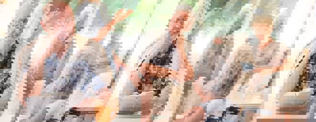 Care home residents having a conversation in a communal space